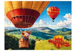 Puzzle 100 pièces souvenir Auvergne illustré d'une vache en montgolfière